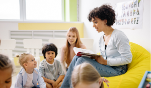 teacher reading a book to show educational differences